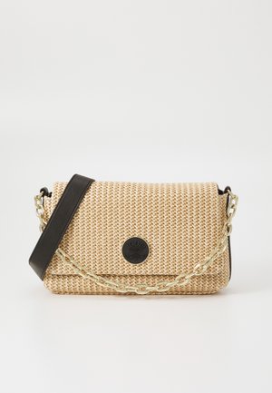 Beige woven handbag with a black leather strap, gold chain accents, and a round black logo detail on the front. Compact rectangular shape.