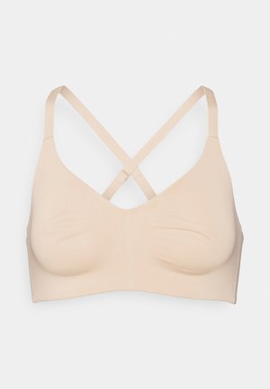 Nahtloser beiger BH mit dreieckigen Cups und verstellbaren gekreuzten Trägern, der für Komfort und Halt konzipiert ist.
