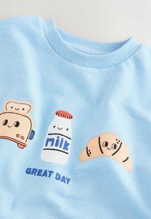 Light blue waffle-textured sweater featuring embroidered toast, milk bottle, croissant, and "GREAT DAY" text in blue.