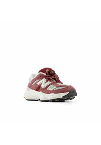 Red and grey athletic shoe with mesh and suede upper, white accent stripes, padded collar, thick sole, and black rubber outsole.