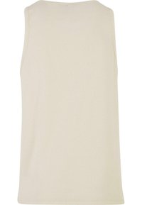 Beige ærmeløs tanktop lavet af ribbet stof. Har en afslappet pasform med rund halsudskæring og ren syning uden synlige logoer.