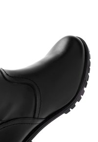 Black leather boot with smooth surface, rounded toe, subtle stitching details, and textured rubber sole for grip.