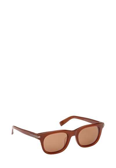 Ruskeat muoviset aurinkolasit, joissa on neliömäiset linssit, metalliset yksityiskohdat sankoissa ja kuvioidut sivupaneelit. Linssit ovat ruskeasävyiset.