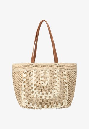 Sac cabas en crochet tissé beige avec motif ajouré, doublure intérieure en tissu uni et deux bretelles en cuir marron.