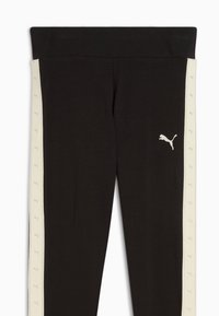 Črne atletske leggings hlače z širokim elastičnim pasom in kremnimi stranskimi črtami z majhnimi ponavljajočimi se logotipnimi vzorci. Meghan mehka, gladka tkanina.
