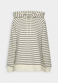 Kremowa bluza w paski z czarnymi poziomymi pasami, z kapturem na sznurki i ściągaczami przy rękawach. Wykonana z miękkiego materiału o luźnym kroju.