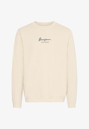 Felpa color crema con maniche lunghe, caratterizzata da un collo rotondo e una stampa testuale "Bonjour Côté d'Azur" in blu scuro.