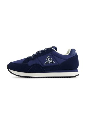 Navy blue athletic shoes with a combination of suede and synthetic materials, featuring a logo, textured accents, and a white sole.
