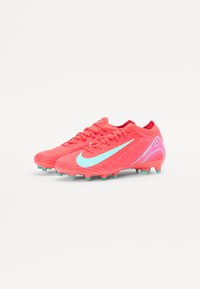 Sporting cleats with a vibrant pink synthetic upper, turquoise accents, textured pattern, and molded studs for traction on grass surfaces.