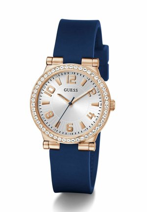 Rose gold ur med sølv skive, blå silicone rem, krystal pynt rundt om bezelen, store timeskalaer og blå visere.