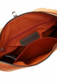 Orange fabric bag interior featuring a red zip pocket, brown leather label embossed with "EMILY & NOAH," and smooth stitching details.