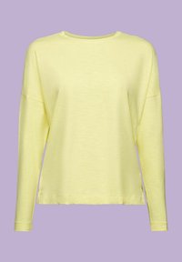 Gelbes Langarmshirt mit rundem Halsausschnitt, lockerer Passform und seitlichen Schlitzen. Hergestellt aus weichem, leichtem Stoff mit einer glatten Textur.