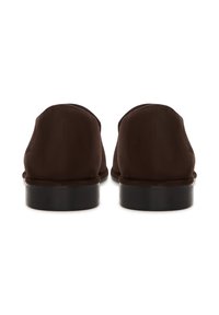 Par mørkebrune formelle sko i ruskind vist bagfra med lave sorte stablede hæle på en hvid baggrund.