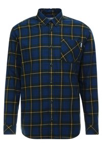Camicia a maniche lunghe a quadri blu e verdi realizzata in tessuto, con colletto, bottoni frontali e taschino sul petto con un piccolo dettaglio del logo.