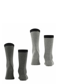 Chaussettes rayées noir et blanc avec une texture douce, présentant un revers noir uni et une conception mi-mollet.