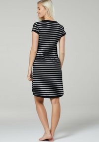 Black and white striped t-shirt dress with a round neckline, short sleeves, and a knee-length hem. Smooth fabric with a relaxed fit.