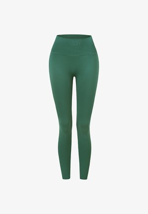 Højtaljede, sømløse mørkegrønne leggings med bred ribbet talje, designet til komfort og aktiv brug.