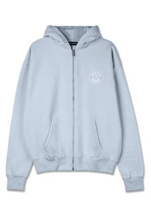 Light blue zip-up hoodie made of soft fabric. Features a front pocket, ribbed cuffs, and a circular logo on the chest.