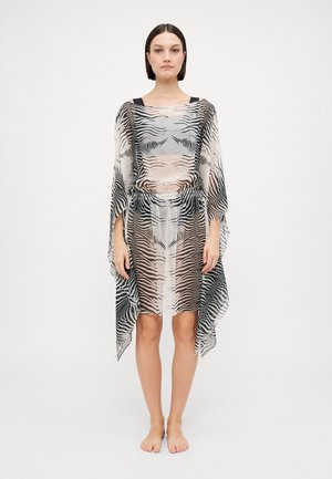 Sheer patterned cover-up with a monochrome zebra print. Loose fit, wide sleeves, and an elastic waist highlight an airy design.