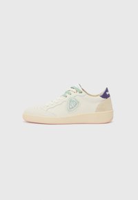 Sneaker featuring a cream vegan leather upper, green and beige laces, diamond-shaped patch with embellishments, and a pink rubber sole.