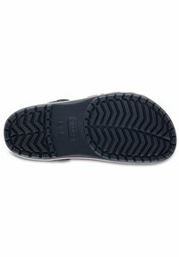 Black rubber shoe sole with herringbone tread pattern and raised grip details. Features a logo and smooth side edge.