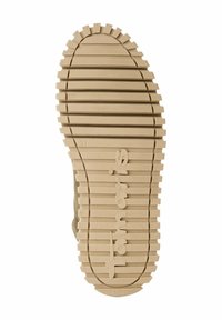Semelle de chaussure beige clair avec une poignée texturée, des rainures horizontales, un léger motif en vagues, et la marque "fabriqué au Portugal" embossée. Taille 37 visible.