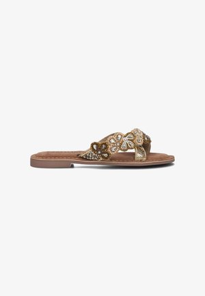 Flache Sandalen mit einer braunen Innensohle. Bead-Blumenmuster in Gold, Weiß und Braun auf den Riemen. Textur ähnlich Wildleder. Offene Zehen-Stil.