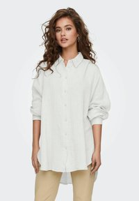 Witte, langarm button-up shirt van textuurstof, met een ontspannen pasvorm en een ronde zoom. Voorzien van een klassieke kraag en opgerolde mouwen.