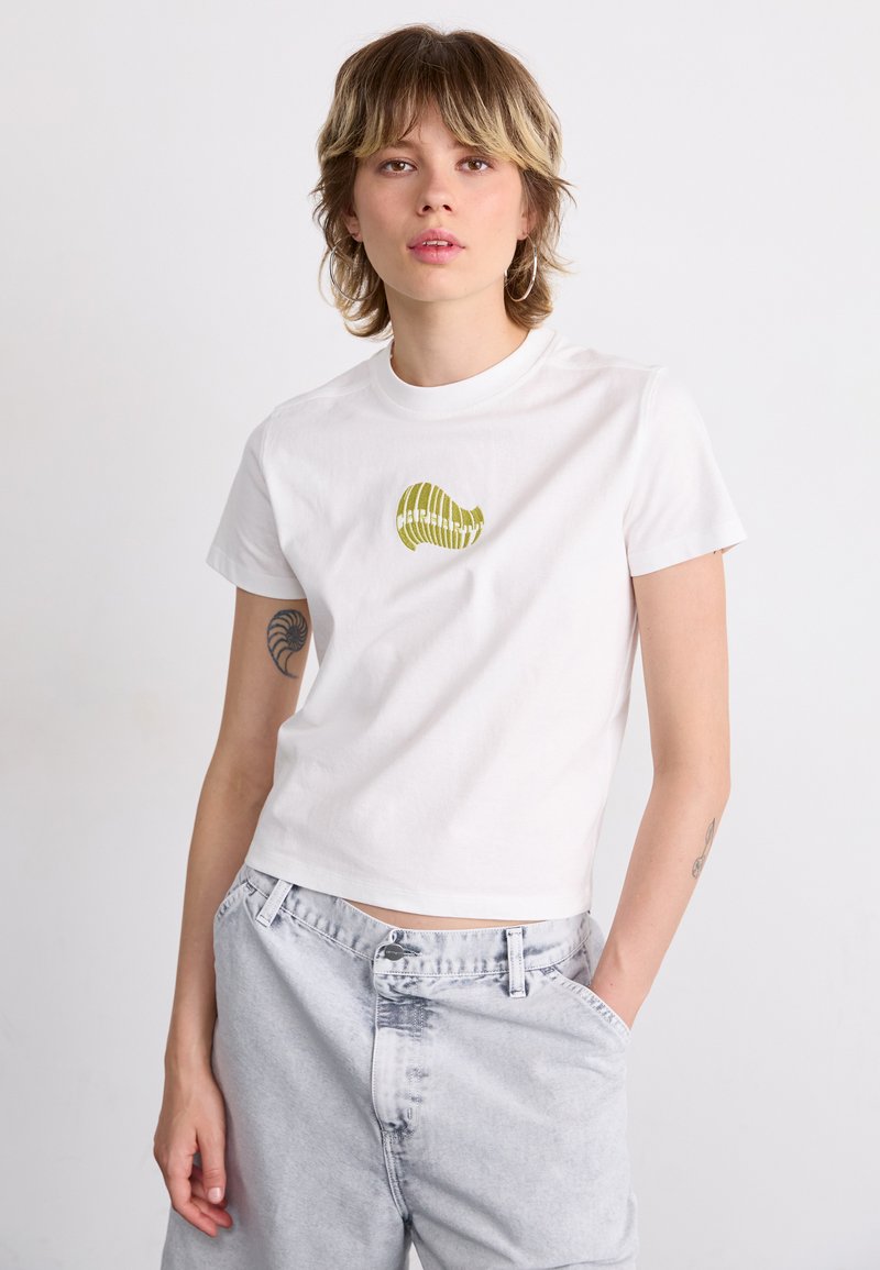White cotton T-shirt with short sleeves and a crew neckline. Features a green graphic design on the chest. Worn with light gray denim pants.