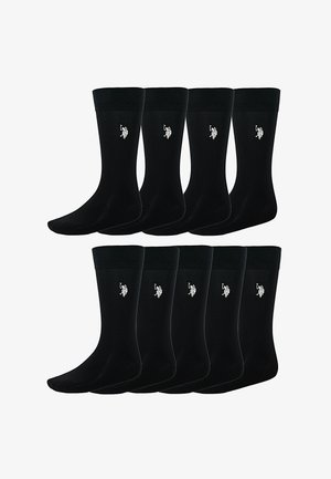 Otte par sorte crew-sokker med ribbede manchetter, hver med en lille hvid broderet polo-spillerlogo på anklen.