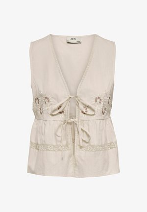Blouse beige sans manches avec un col en V profond, fermeture à nouer à l'avant, broderie florale sur la poitrine et bordure en dentelle près de l'ourlet.