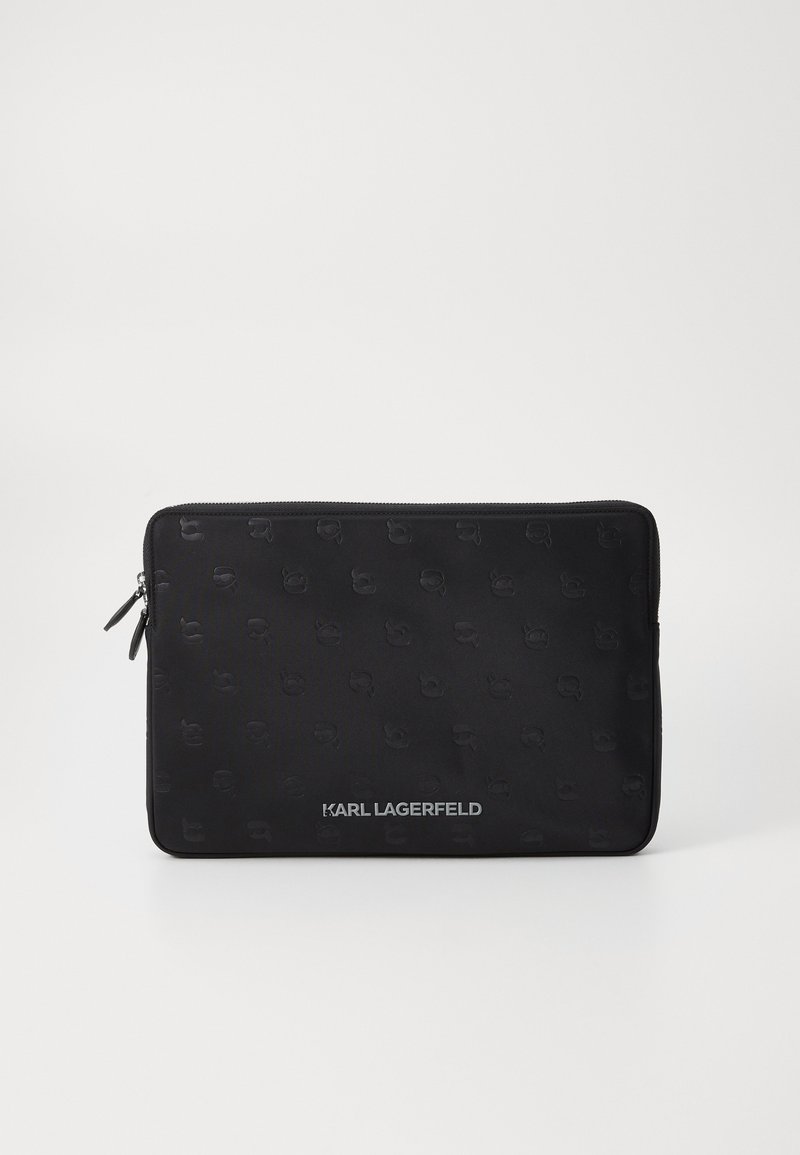 Black zippered laptop sleeve featuring a smooth texture and an embossed logo pattern, with a metal logo detail at the bottom.