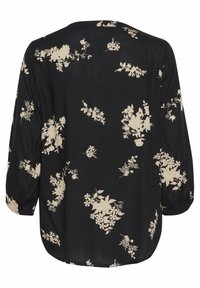 Blusa negra con estampado floral en beige, mangas largas con puños fruncidos y diseño de corte relajado. Tejido suave con escote redondo.