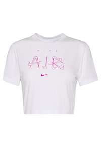 Bílé zkrácené tričko vyrobené z bavlny. Na přední straně se nachází růžový grafický n�ápis "NIKE AIR" a logo. Krátké rukávy, kulatý výstřih.