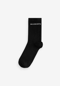 Calzini neri a coste con punta senza cuciture e logo bianco "ALLSAINTS" sul risvolto superiore. Realizzati in un materiale morbido e stretchy.