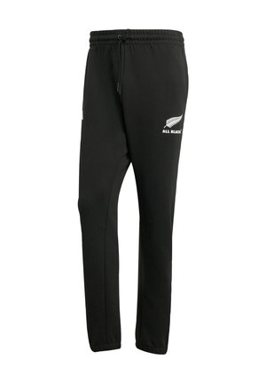 Pantalons de survêtement noirs en tissu mélangé coton, dotés d'une taille élastique avec cordon de serrage et d'un logo "All Blacks" blanc sur la jambe gauche.