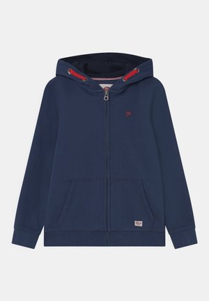 Felpa con zip di colore blu navy in misto cotone. Presenta un logo frontale, dettagli con cordoncino rosso e due tasche anteriori. Texture liscia, design casual.