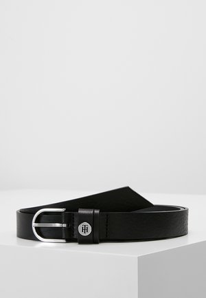 Black leather belt with a silver rounded buckle and engraved metal logo detail on the belt loop, displayed on a white surface.