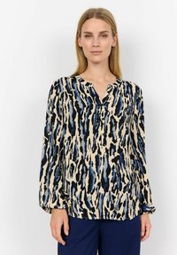 Blusa a maniche lunghe in tessuto beige con un motivo astratto blu e nero. Design a V con dettaglio a bottone sul colletto.