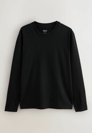 Langærmet sort t-shirt lavet af bomuld med rund hals og diskret branding på brystet. Glat tekstur og almindelig pasform.