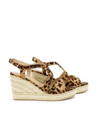 Leopard print wedge sandals with cross straps, soft suede material, jute-wrapped platform, and a rounded toe shape.