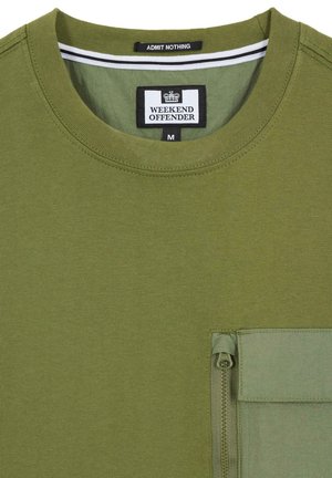 Olíva zöld, rövid ujjú, puha pamutból készült póló, kerek nyakkivágással és cipzáros zsebbel.