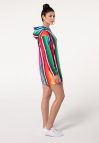 Gestreiftes Kapuzenkleid in mehreren Farben mit gerippter Textur. Es zeichnet sich durch lebendige vertikale Streifen in Pink, Grün, Blau und Orange aus. Mit Kapuze.