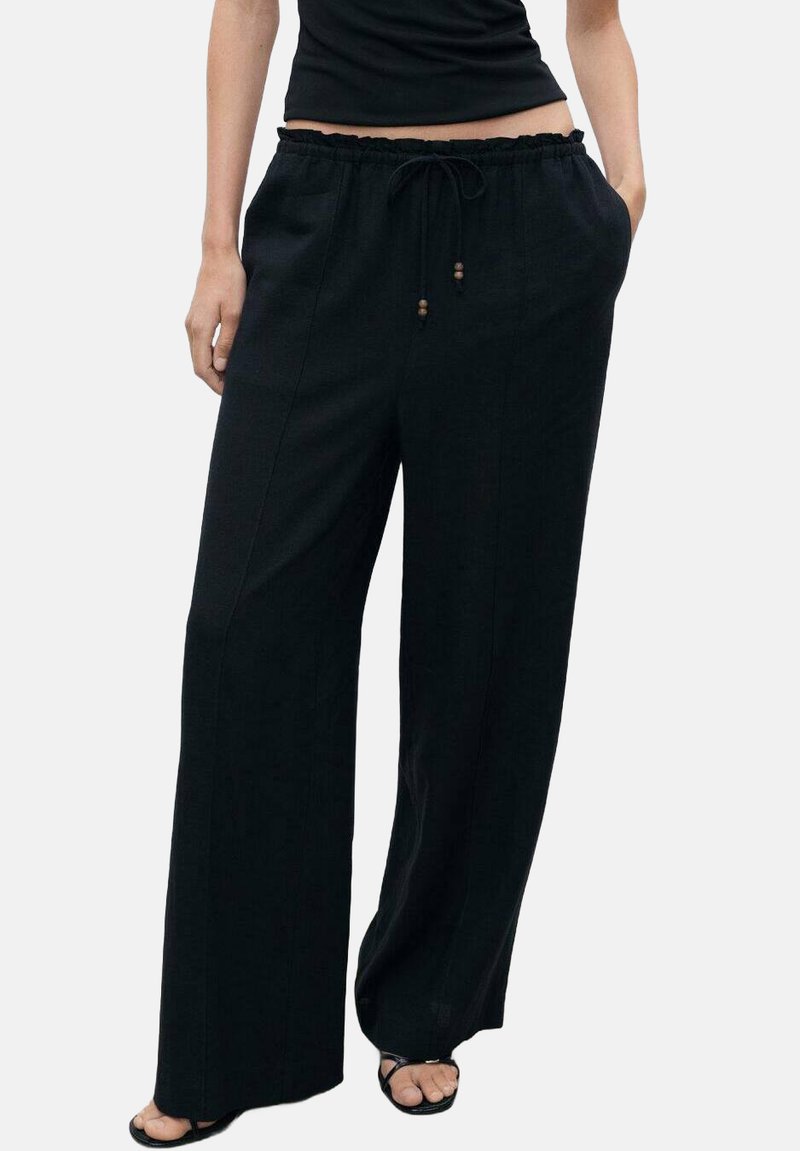 Black wide-leg pants with a relaxed fit, drawstring waist, and wooden bead accents. Made of soft, lightweight fabric with no patterns.