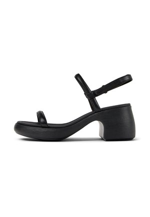 Black heeled sandals with an open toe and ankle strap. Made of smooth leather with a chunky, textured heel and curved sole design.