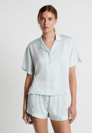 Light green short-sleeve pajama set featuring a button-up top with a collar and matching shorts. The fabric has a subtle geometric pattern.