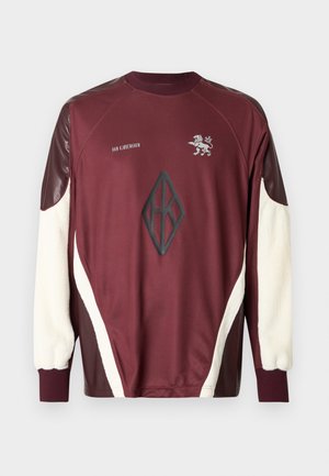 Maroon sweatshirt with cream and dark brown accents. Features a textured front logo, raglan sleeves, and elastic cuffs.