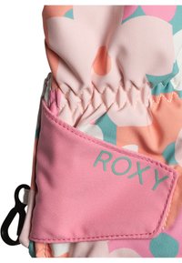 Tissu coloré avec un motif floral aux teintes de rose, pêche et bleu canard. Il présente une étiquette Roxy rose et un ruché élastique en haut.