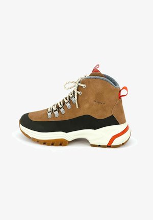 Brown and black suede high-top hiking boot with gray lining, white midsole, rubber outsole, and red heel accent. Features metal eyelets and laces.