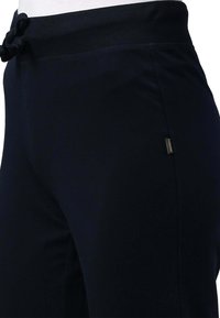 Pantaloni da jogging atletici blu navy realizzati in tessuto morbido, con vita a coste, dotati di coulisse e un piccolo logo sul lato.